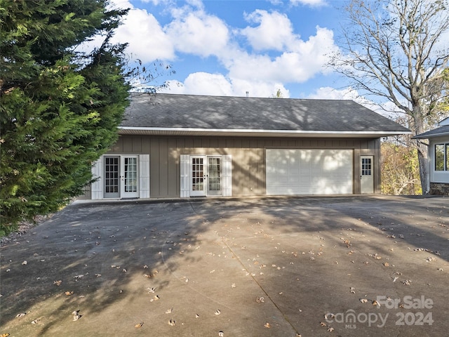 exterior space with french doors and a garage