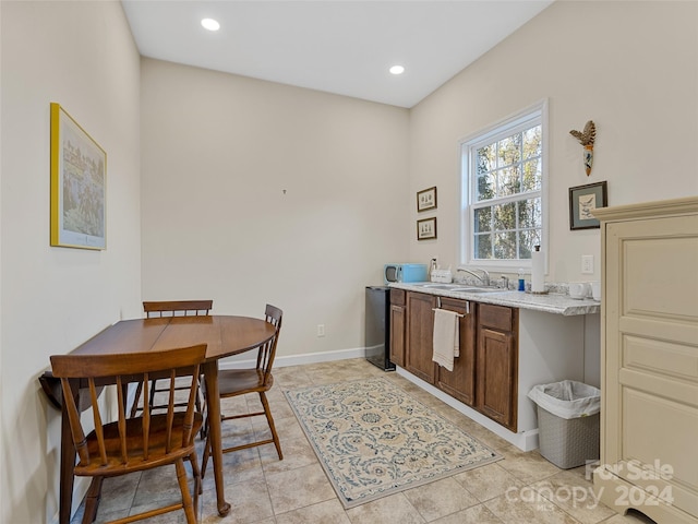 dining space with light tile patterned floors and sink