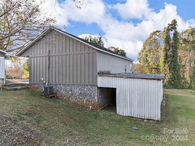 exterior space featuring a yard and cooling unit