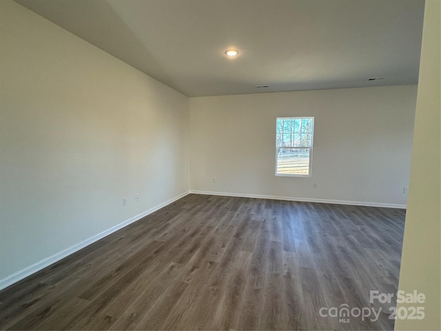 empty room featuring dark hardwood / wood-style flooring