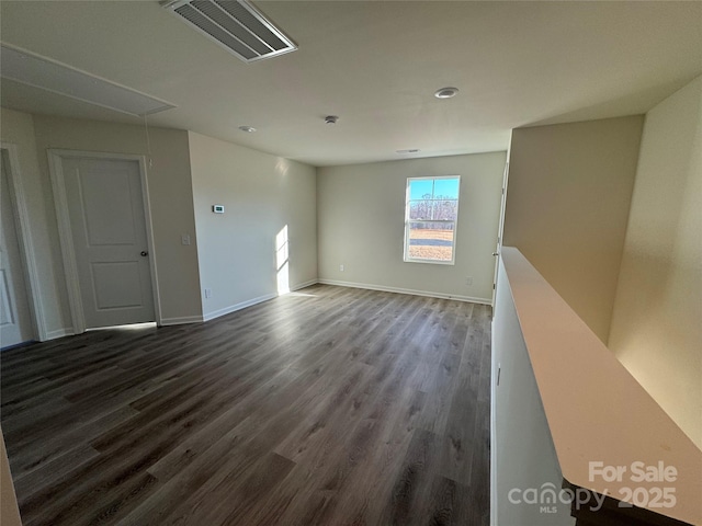 empty room with dark wood-type flooring