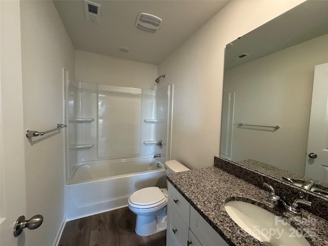 full bathroom featuring hardwood / wood-style floors, vanity, toilet, and shower / bathtub combination