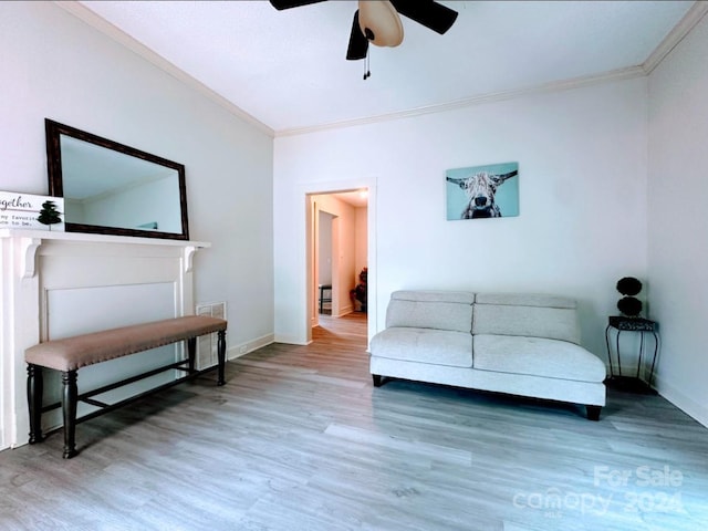 living room with hardwood / wood-style flooring, ceiling fan, and ornamental molding