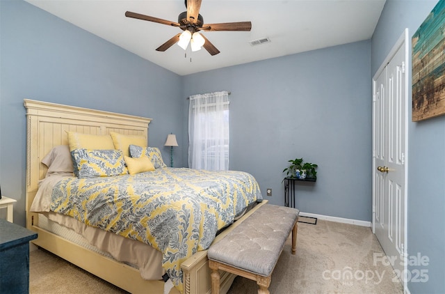 bedroom with ceiling fan and light carpet