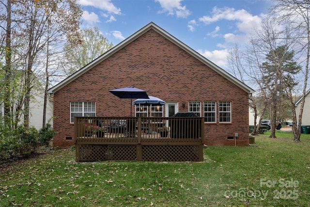 back of house featuring a lawn and a deck