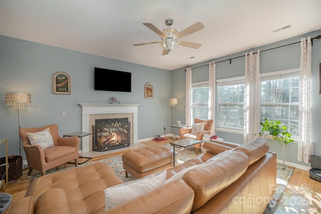 living room featuring ceiling fan and light wood-type flooring