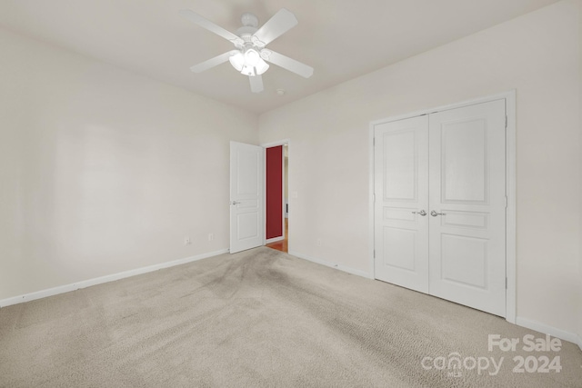 unfurnished bedroom with carpet, a closet, and ceiling fan