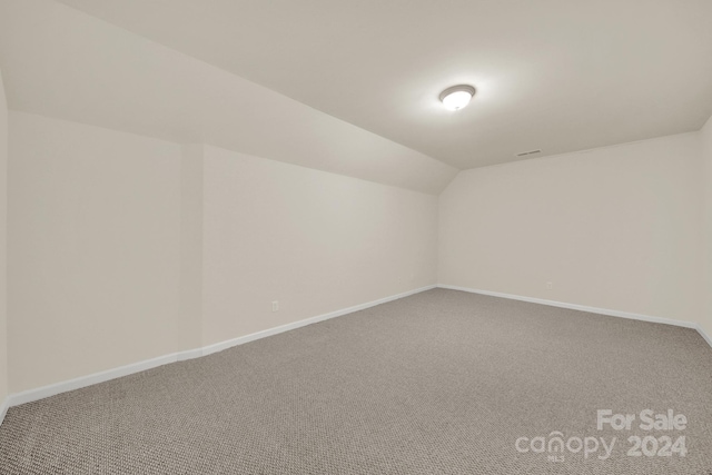 bonus room with carpet and vaulted ceiling