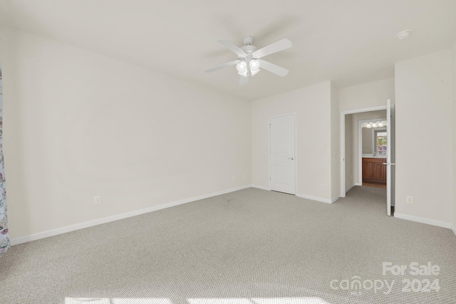 carpeted empty room featuring ceiling fan