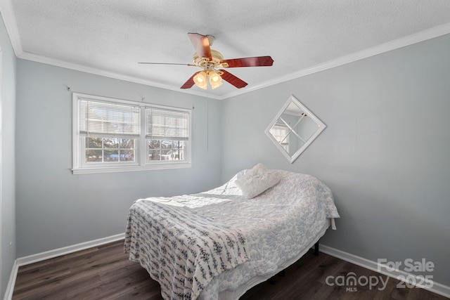 bedroom with ceiling fan, dark hardwood / wood-style flooring, crown molding, and a textured ceiling