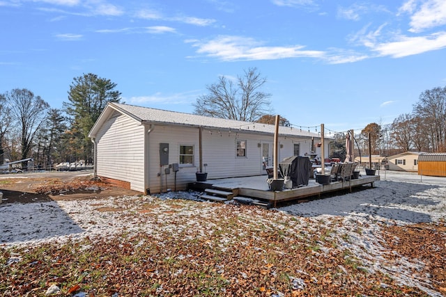 rear view of house featuring a deck