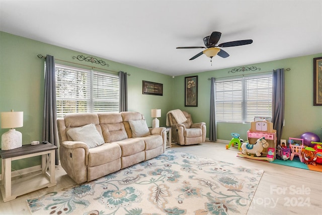 living room featuring hardwood / wood-style floors, plenty of natural light, and ceiling fan