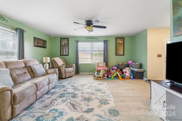 living room featuring light wood-type flooring and ceiling fan