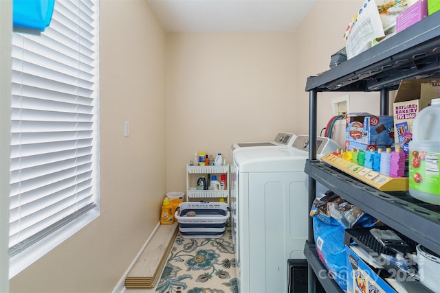 clothes washing area with separate washer and dryer