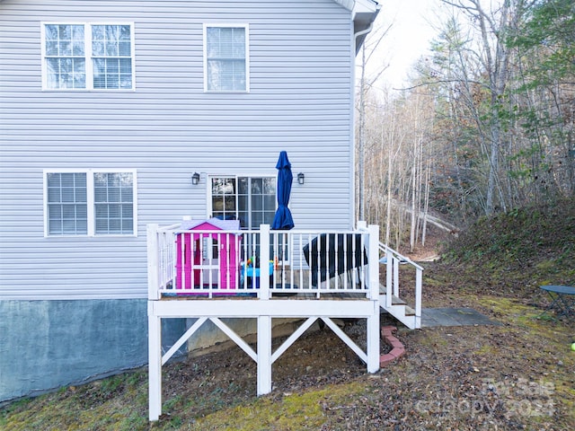 rear view of property featuring a deck