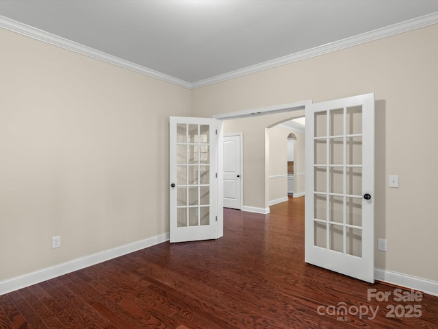 empty room featuring french doors, crown molding, and dark hardwood / wood-style flooring