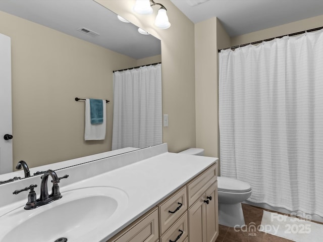 bathroom featuring vanity, curtained shower, tile patterned floors, and toilet