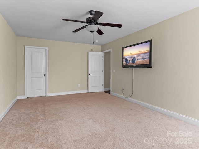 unfurnished room featuring light colored carpet and ceiling fan