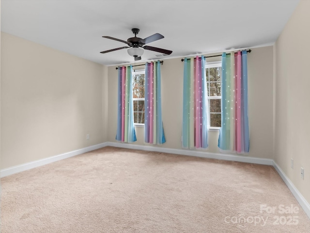 carpeted spare room with ceiling fan