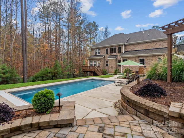 view of swimming pool featuring a deck and a patio area