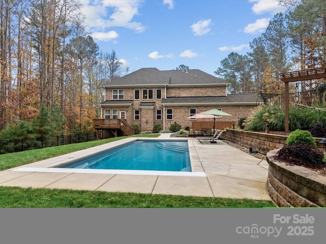 view of pool with a patio area and a wooden deck