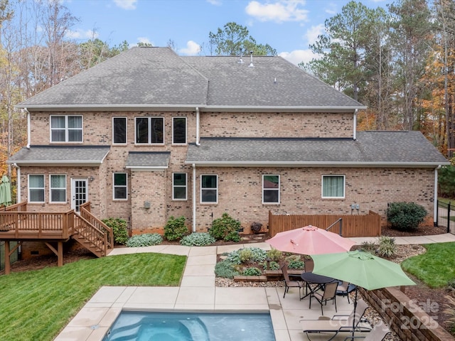 back of house featuring a pool side deck, a patio, and a yard