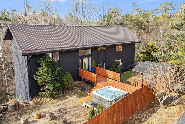 rear view of house featuring a wooden deck