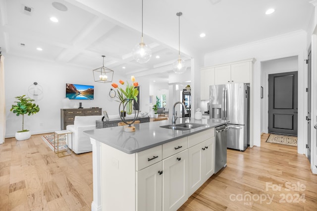 kitchen featuring a center island with sink, white cabinetry, stainless steel appliances, and light hardwood / wood-style flooring