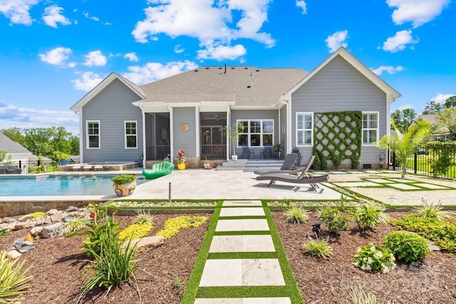 rear view of house with a patio and a sunroom