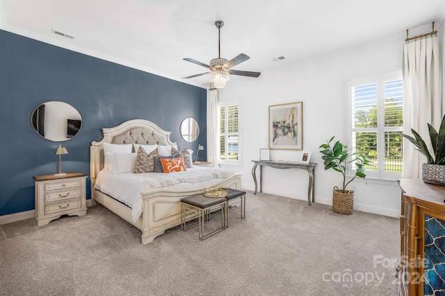 bedroom with ceiling fan, light carpet, and multiple windows