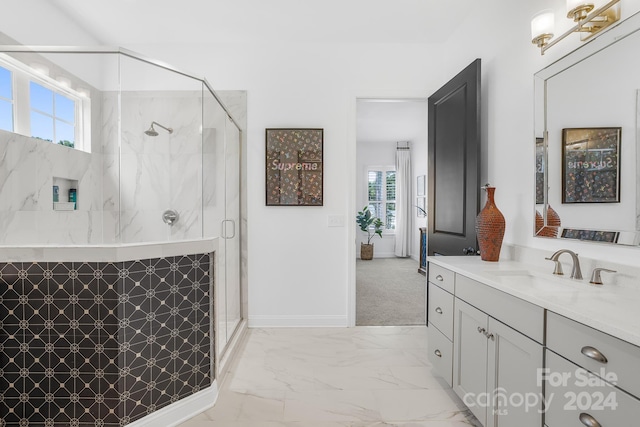 bathroom with plenty of natural light, a shower with door, and vanity