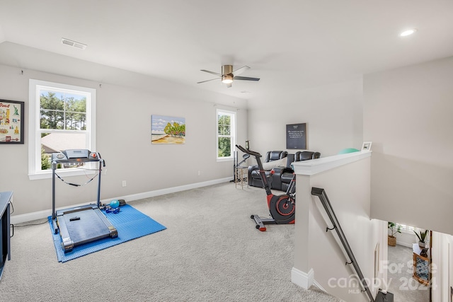 exercise room with light carpet, a wealth of natural light, and ceiling fan