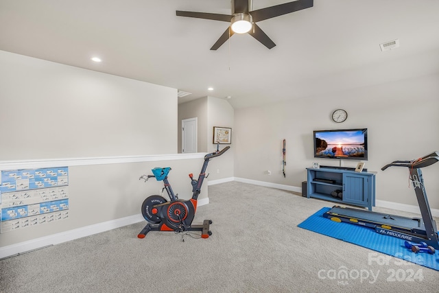 workout area with ceiling fan and light carpet