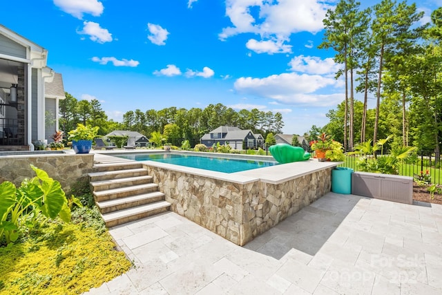 view of swimming pool featuring a patio area