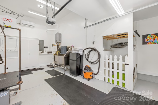 garage featuring a wall mounted AC, electric panel, stacked washing maching and dryer, and a garage door opener