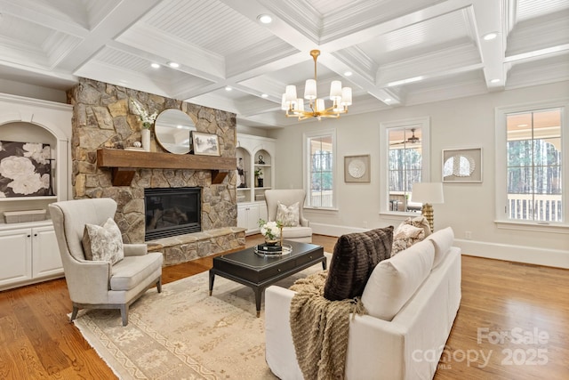 living room featuring light wood-style floors, beamed ceiling, and a stone fireplace