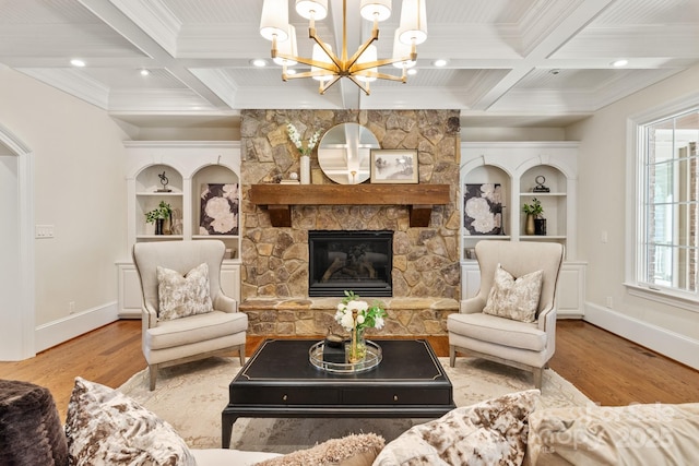 living area with beam ceiling, coffered ceiling, and wood finished floors