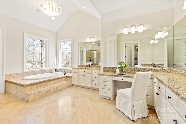 bathroom featuring a garden tub, vaulted ceiling, a shower stall, vanity, and a chandelier