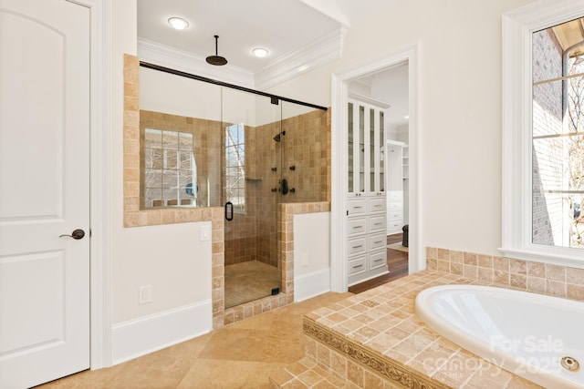 bathroom with a bath, a shower stall, and crown molding