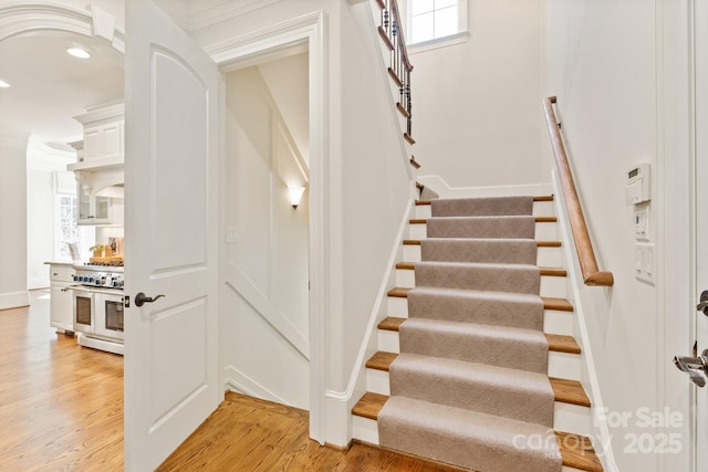 stairs featuring baseboards and wood finished floors