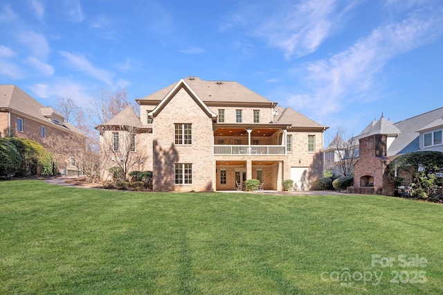 back of house with brick siding, a lawn, a fireplace, and a balcony