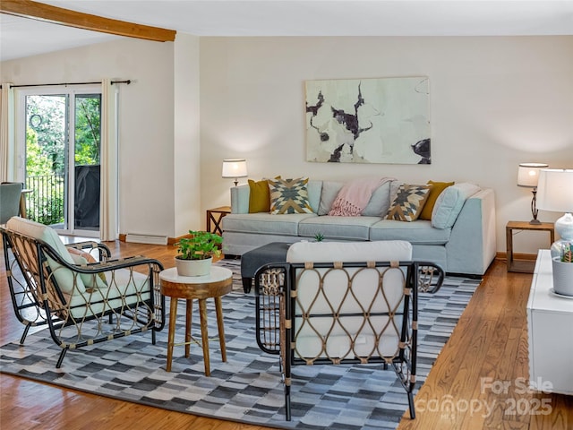 living room featuring hardwood / wood-style flooring and lofted ceiling with beams