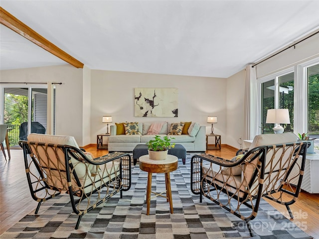 living room with beam ceiling and hardwood / wood-style flooring