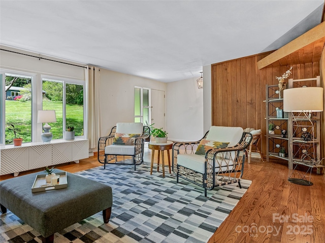 living area featuring hardwood / wood-style floors and wood walls