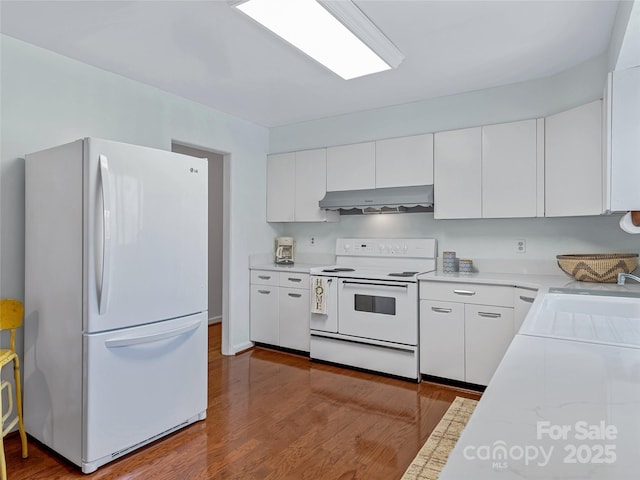 kitchen featuring white cabinetry, sink, white appliances, and hardwood / wood-style flooring