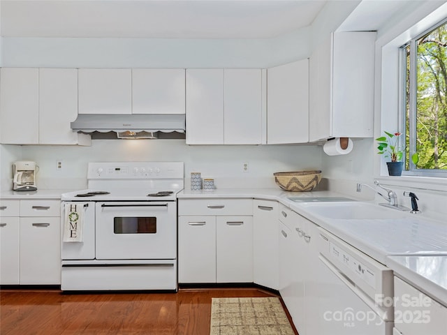 kitchen with range hood, sink, white appliances, dark wood-type flooring, and white cabinets