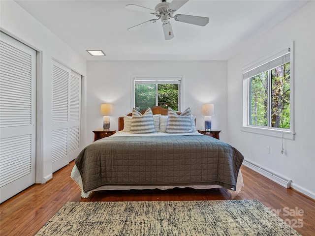 bedroom featuring ceiling fan, dark hardwood / wood-style flooring, and a baseboard radiator