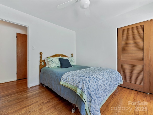 bedroom with ceiling fan and hardwood / wood-style flooring