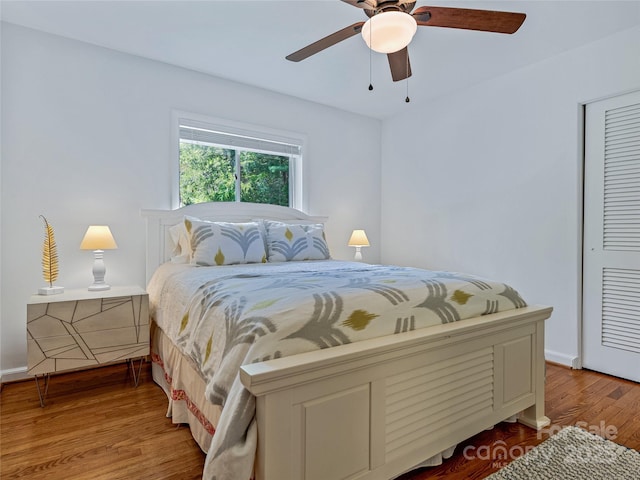 bedroom with ceiling fan, a closet, and hardwood / wood-style floors