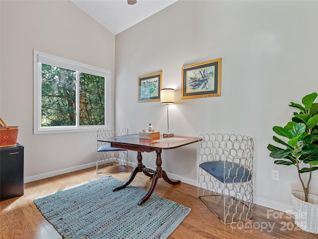 office with lofted ceiling and light hardwood / wood-style flooring